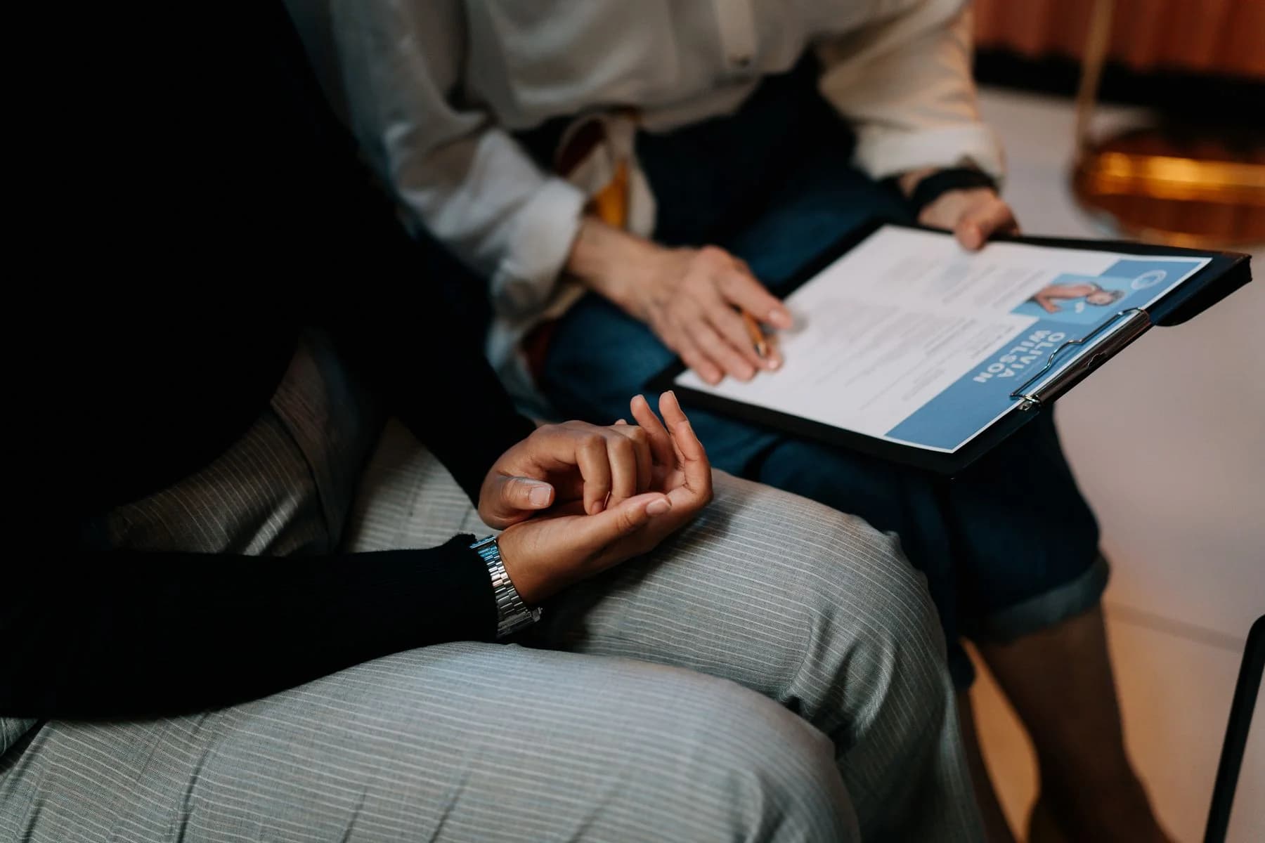 A hiring manager and colleague reviewing a candidate profile